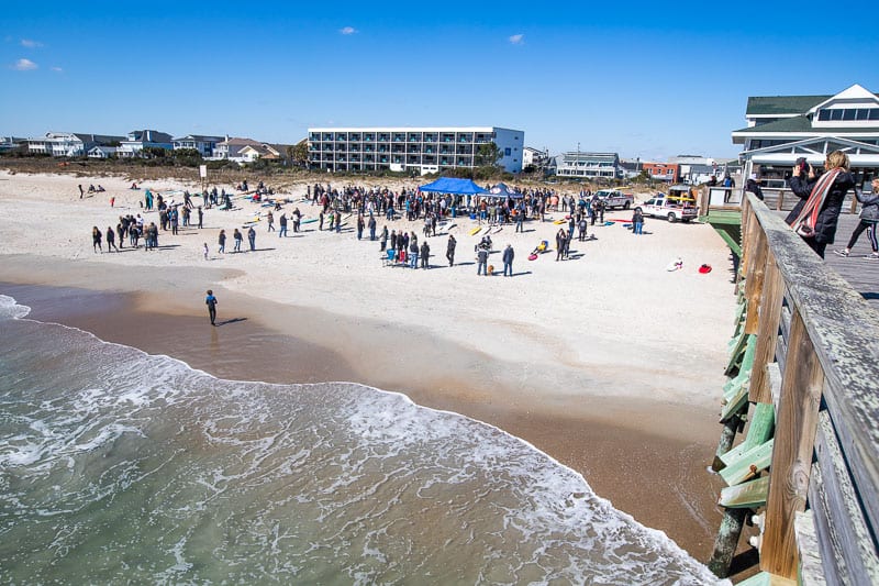 Surfers gathered for a morning paddle at Crystal Pier