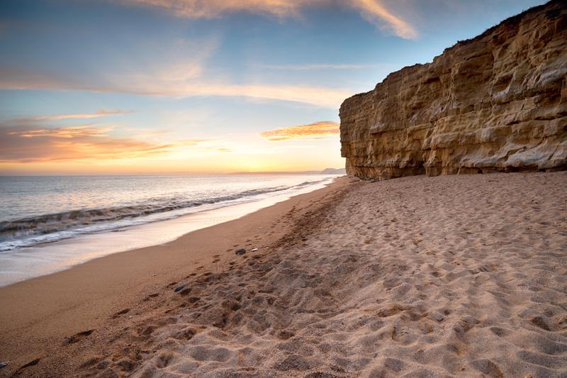 Sunset over the cliffs at Hive Beach at Burton Bradstock near Bridport on the Dorset coast