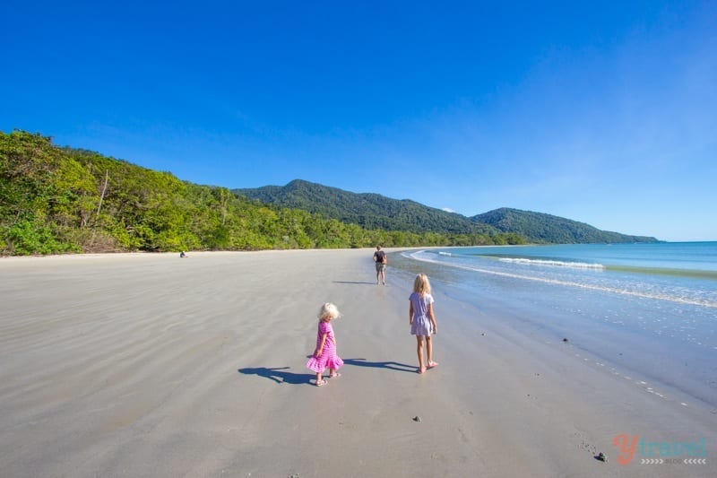 kids walking along the beach