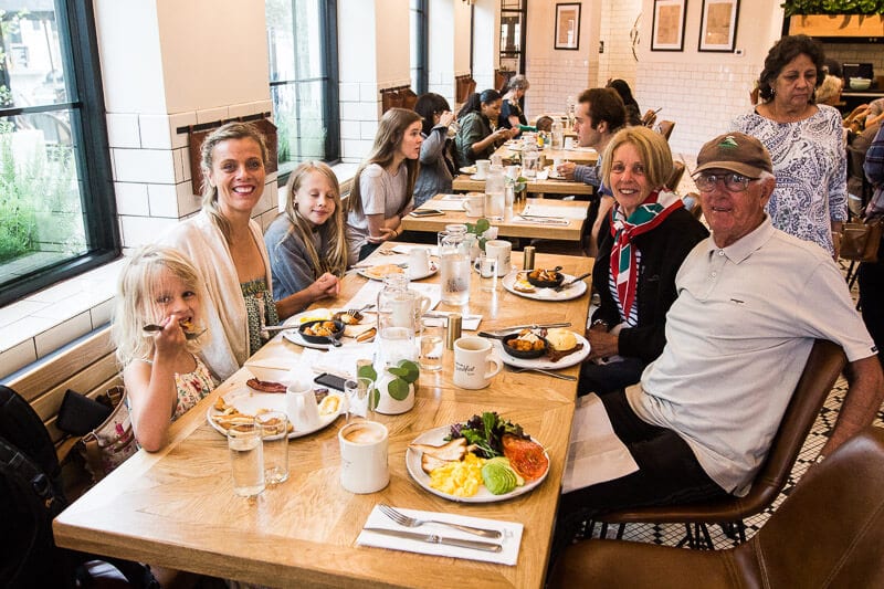 family sitting at magnolia table restaurant 