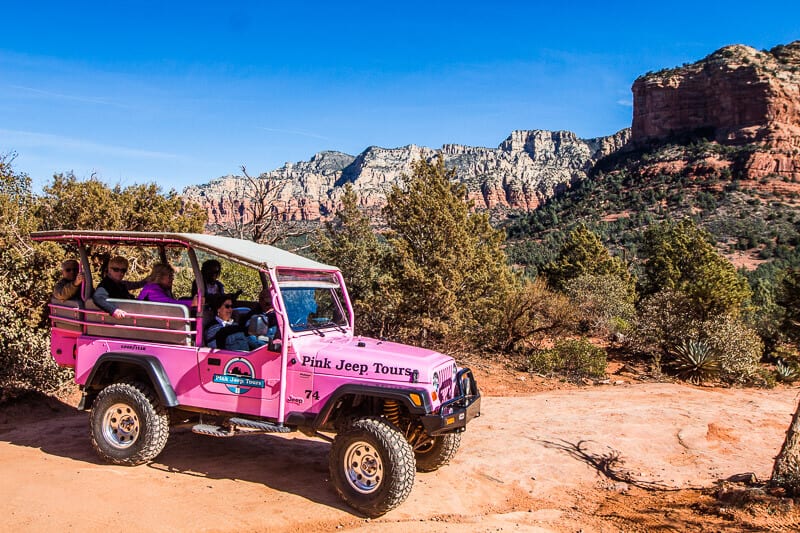 car parked in a canyon on a rock