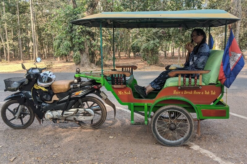 woman sitting in Cambodian tuk-tuk while visiting Angkor Wat