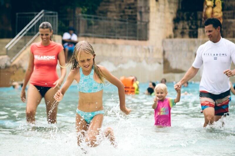 family running out of swimming pool