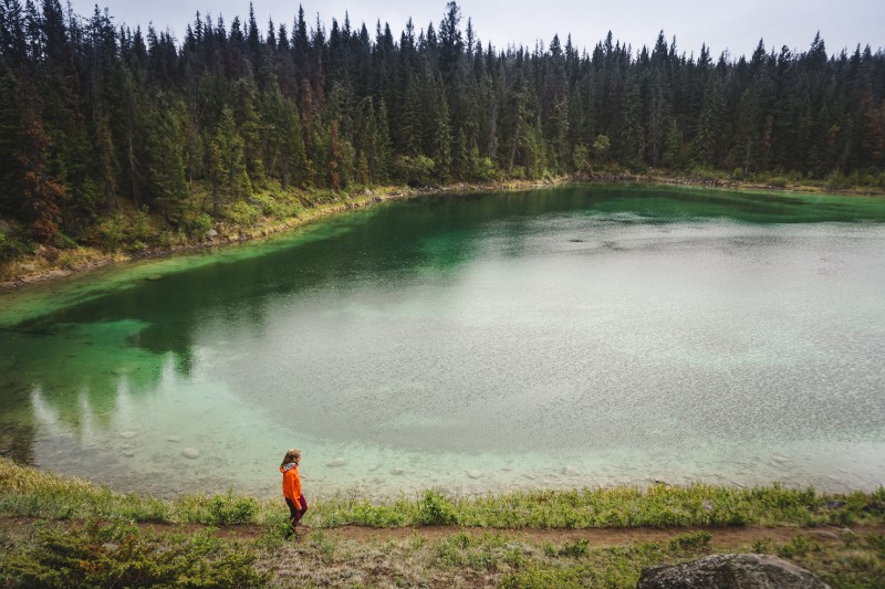 young girl on edge of lake. Valley of the Five Lakes, Jasper National Park