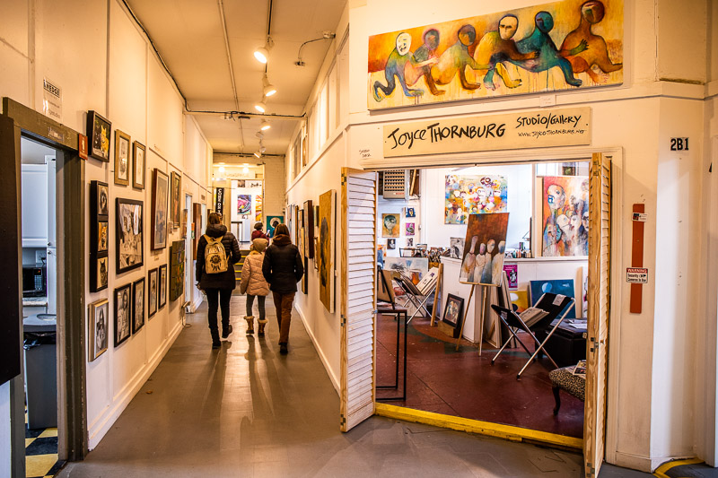 mother and two daughters walking in art studio