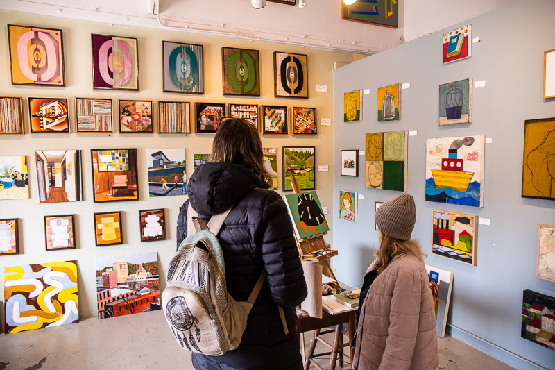 mum and daughter looking at art in studio