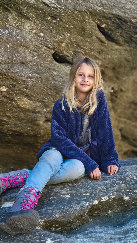 girl sitting on rock