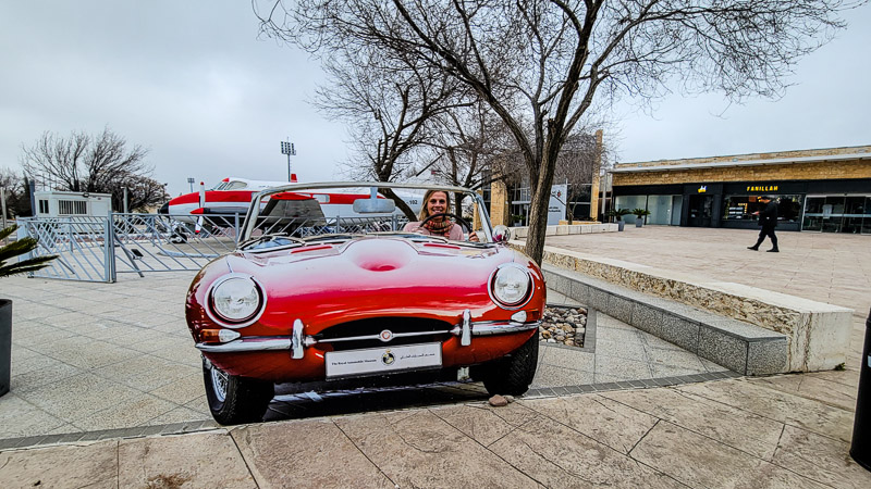 girl sitting in red car 