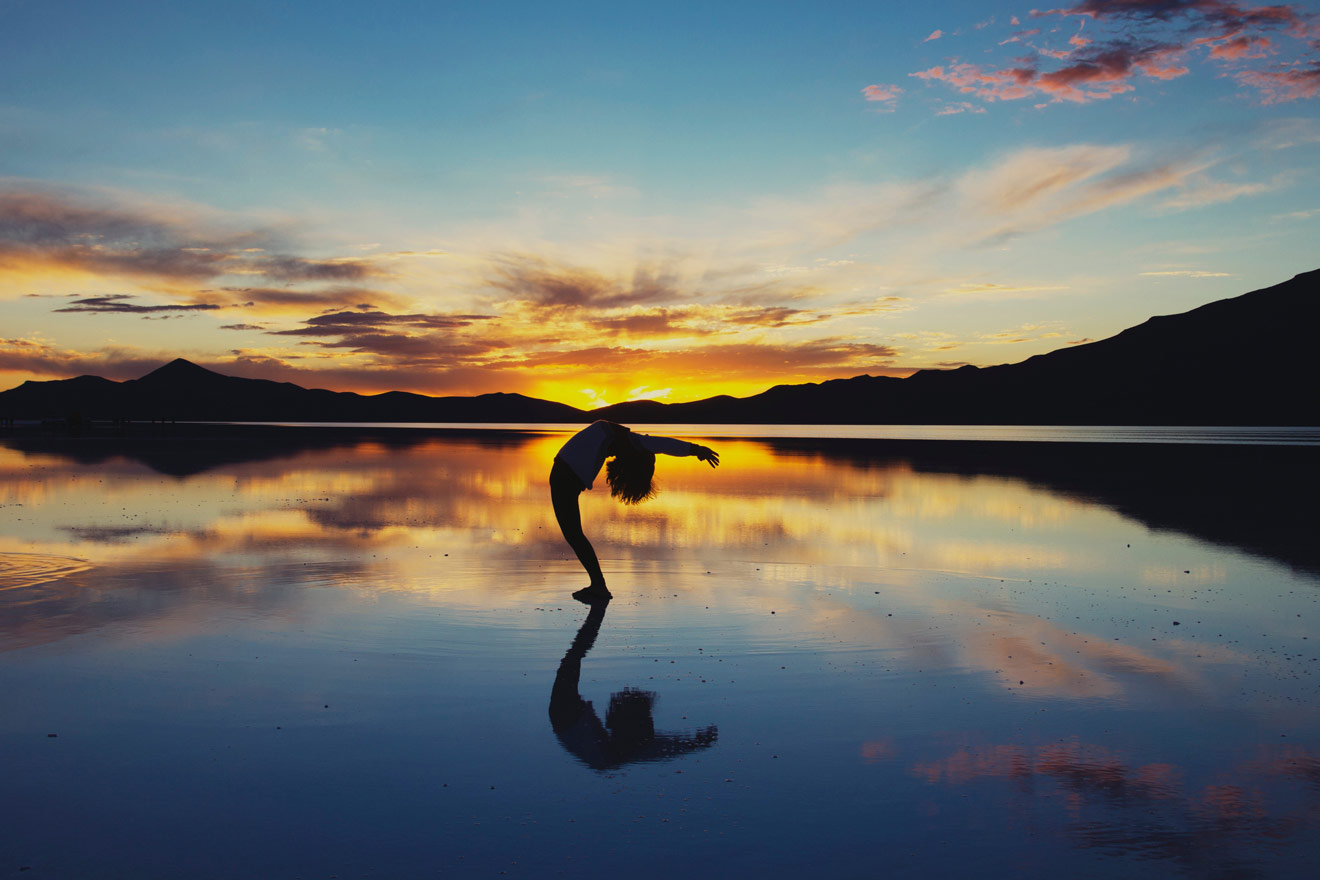 A silhouette of someone practicing yoga in Playa del Carmen, Mexico