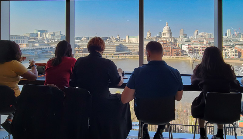 people looking at view of st paul and river thames from tate modern bar