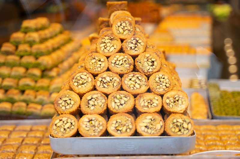 a tray full of baklava arranged in a pyramid shape