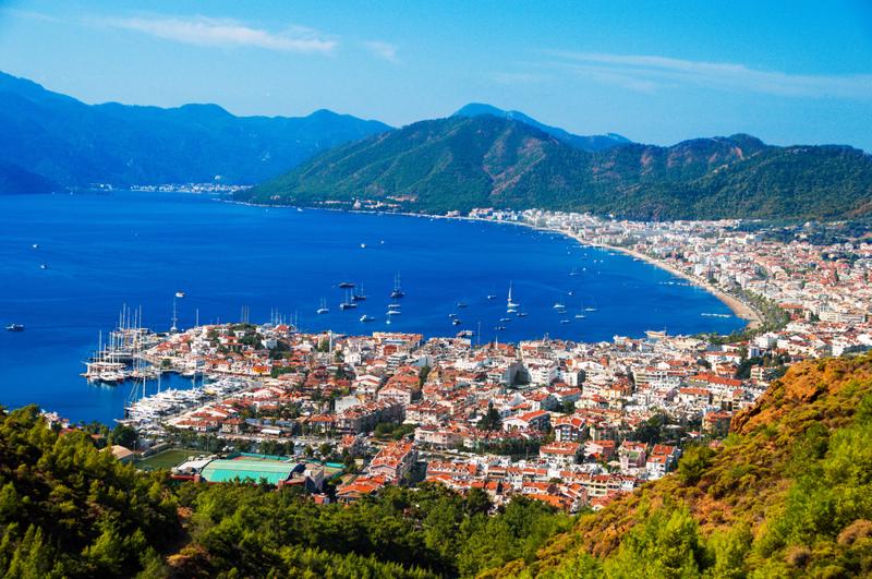 curving Bozburun Peininsual with brilliant blue water, rugged mountains in the backgrounds and houses along the bay shoreline