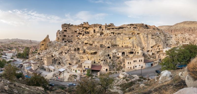 rock village surrounded by mountains with caves in them