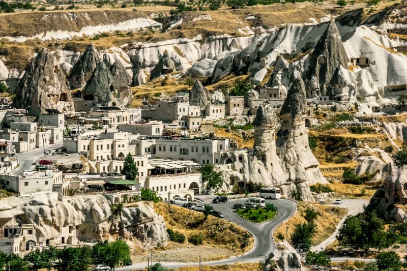 white buildings and caves carved into white cliffs goreme