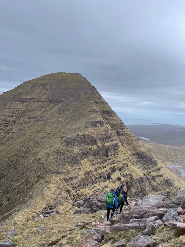 two hikers on a rocky trail in the north west highlands