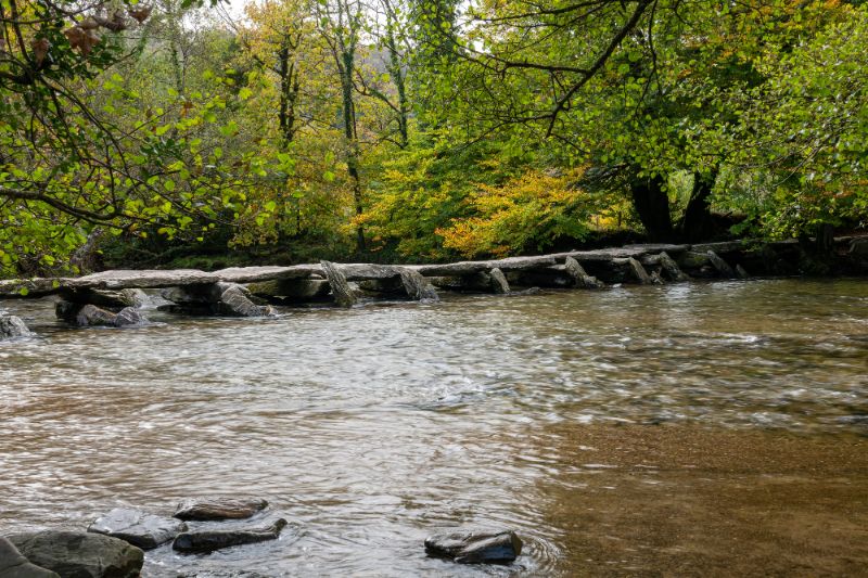 steon bridge over water known as the clapper bridge tarr steps exmouth england