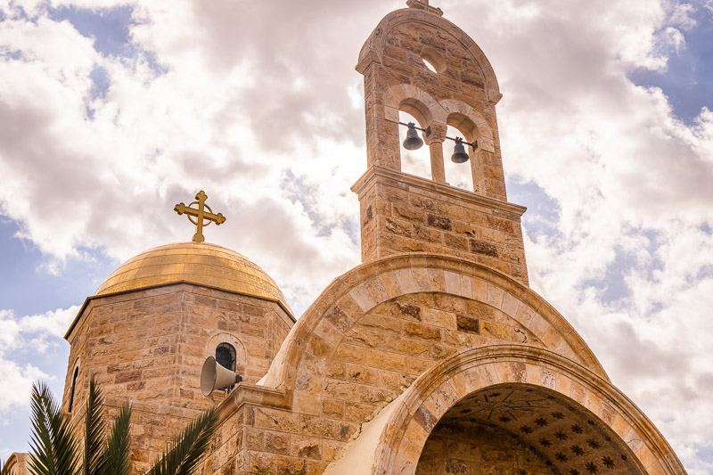 gold dome and bell tower on brick church