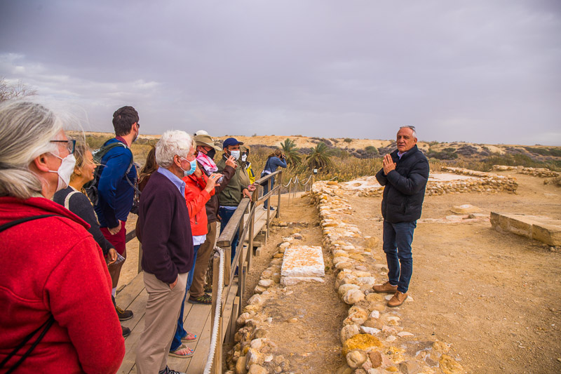 man leading a group tour at Elijah's hill