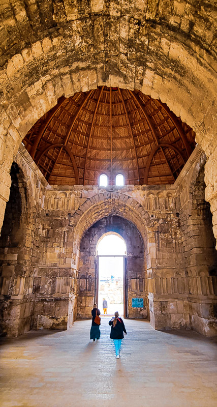 two women walking under a dome in an old palace