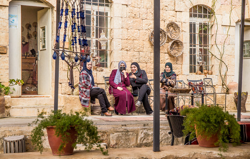 arabic women sitting down talking and laughing