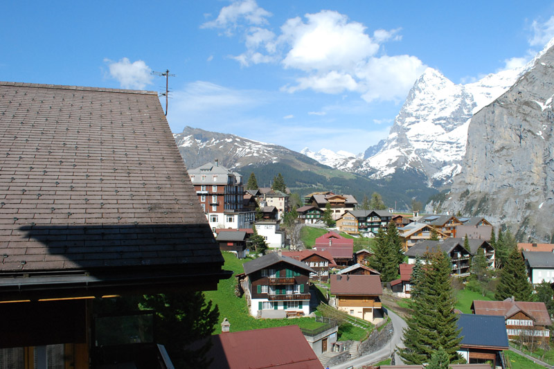 a small village sandwiched between snow covered peaks