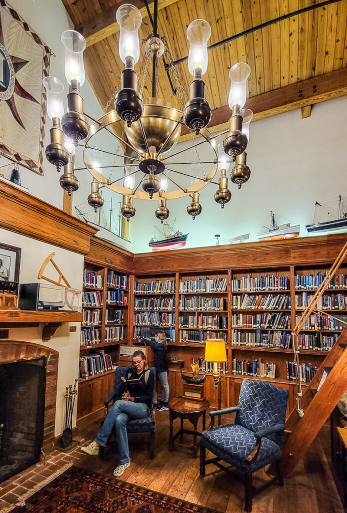 a woman reading a book in a library