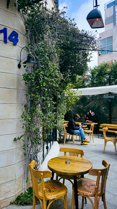 man sitting on vine covered patio amman