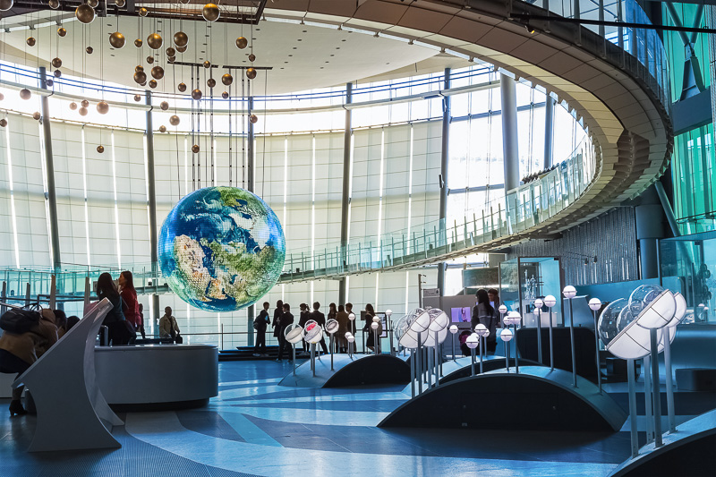 Peopel standing under Hanging globe inside The National Museum of Emerging Science and Innovation , 