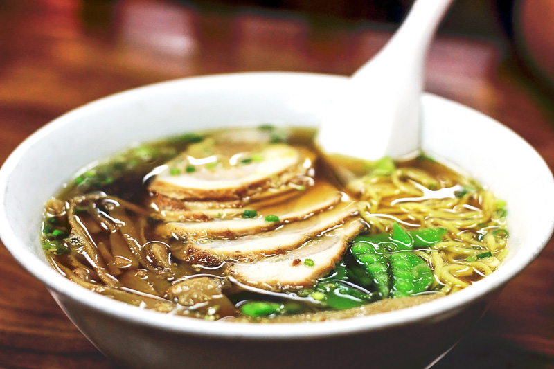 a bowl of Japanese ramen soup with pork