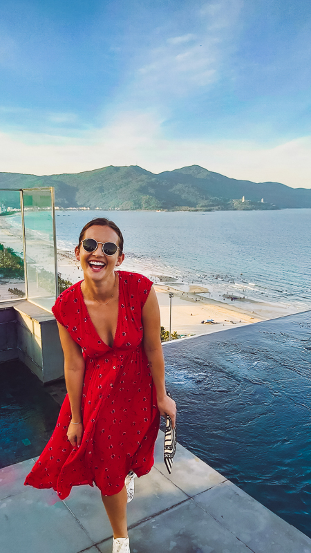 woman in red dress at a roof top bar da nang