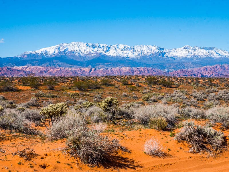 Sand Hollow State Park orange sand and snow capped mountains