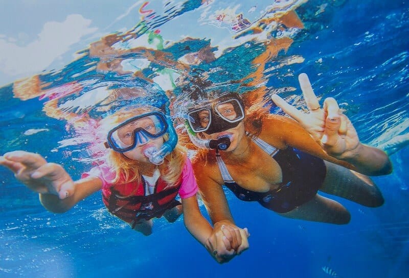 woman and girl posing to camera while Snorkel the Great Barrier Reef