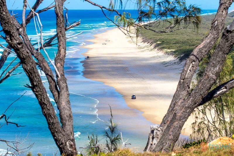 aerial view of car driving on 75 Mile Beach, Fraser Island