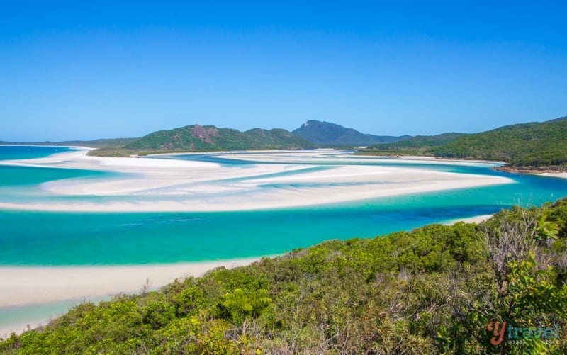 swirling green water and white sand of whitehaven beach 