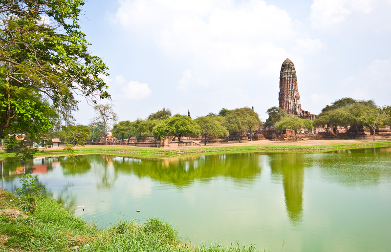 part of the ruins of Wat Phra Ram in Ayutthaya with green lake in front