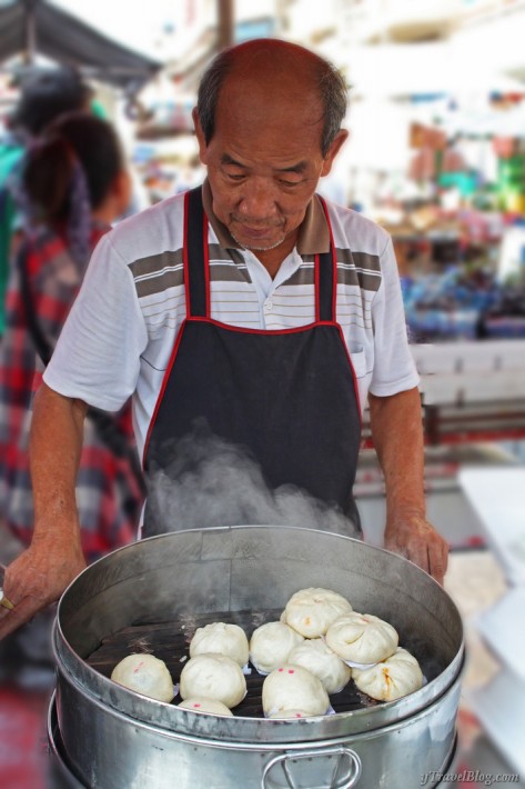  food vendor cooking dumplings in stall