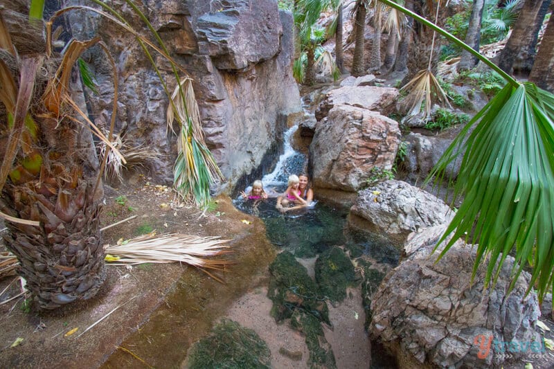 woman and girls sitting in the water at Zebedee Springs, El Questro