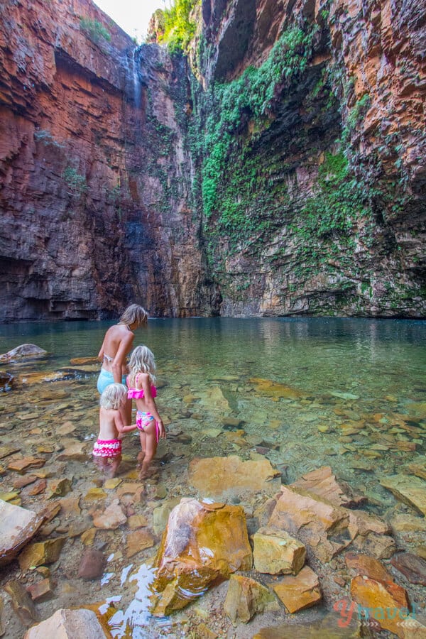 woman and girls walking into swimming hole at Emmas Gorge