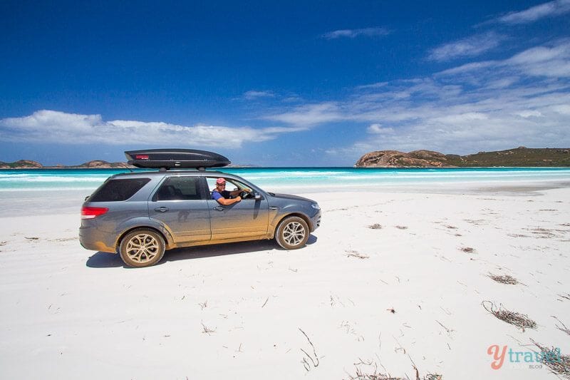 man driving car on beach at Lucky Bay, Esperance, Western Australia