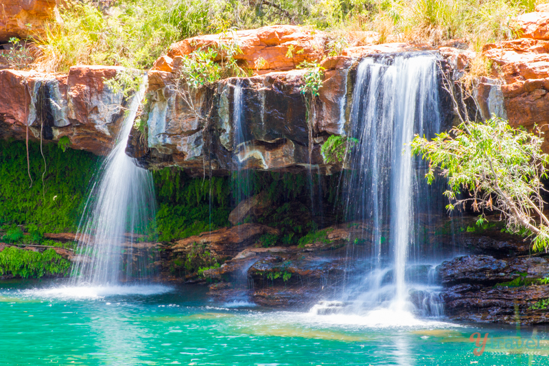 twin waterfalls spilling into water