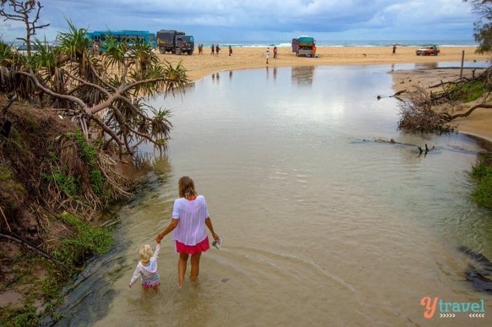 people walking through water