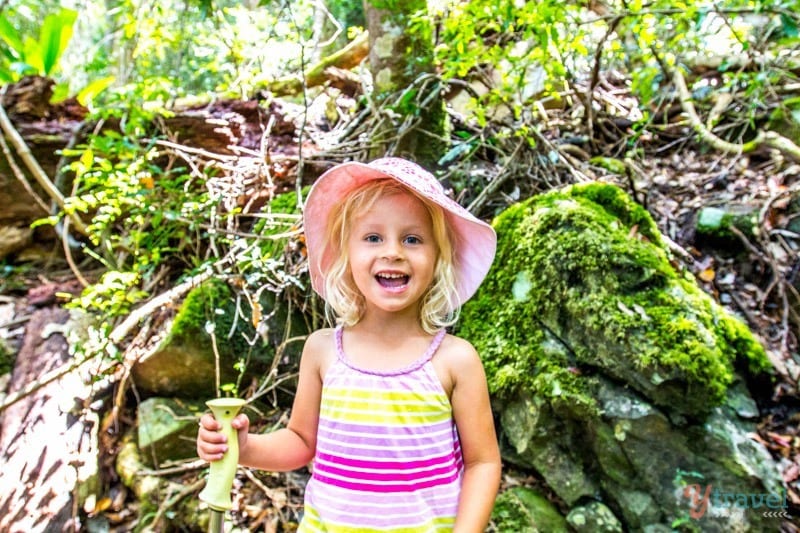 A little girl standing in a garden