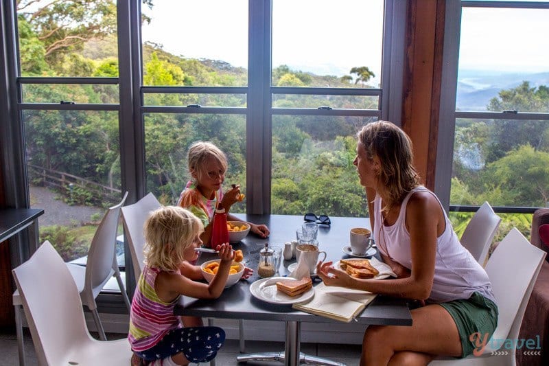 people sitting at a table in front of a window