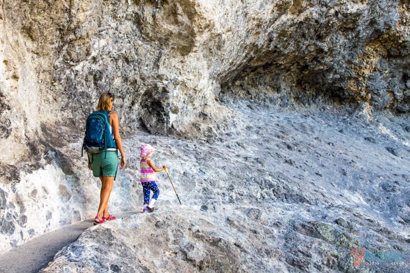 people walking on a rocky trail