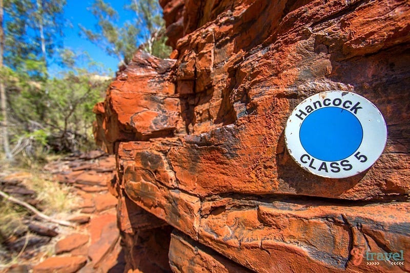 a sign on a rock tower