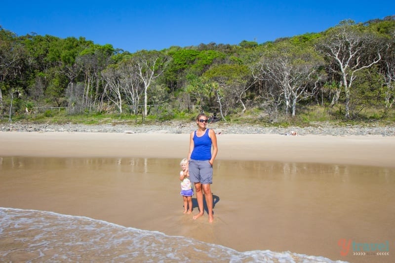 people standing on the beach