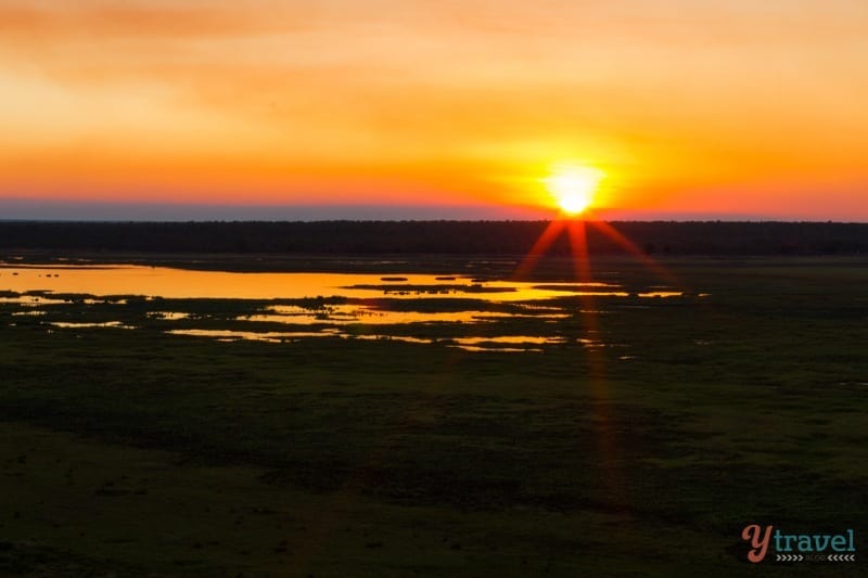 kids stting on rocks at Sunset at Ubirr, Kakadu National Park, Northern Territory, Australia