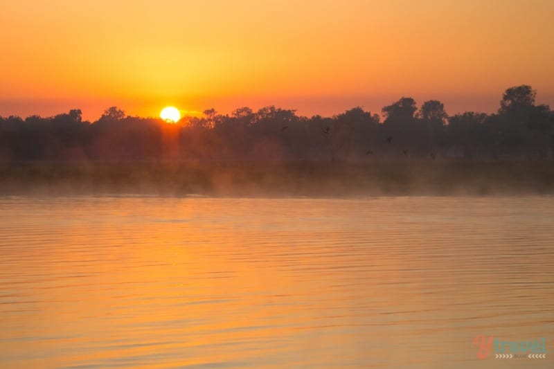 A sunrise over a body of water