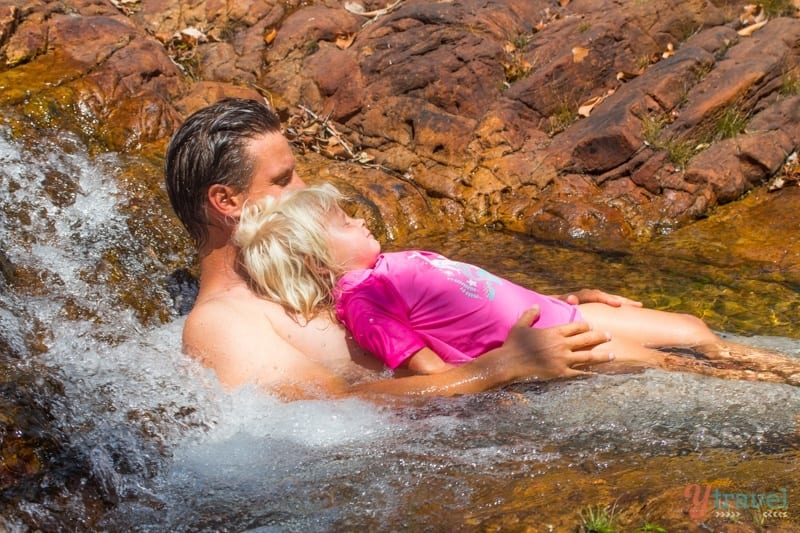 people laying in a river