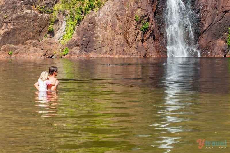 A large waterfall over a body of water